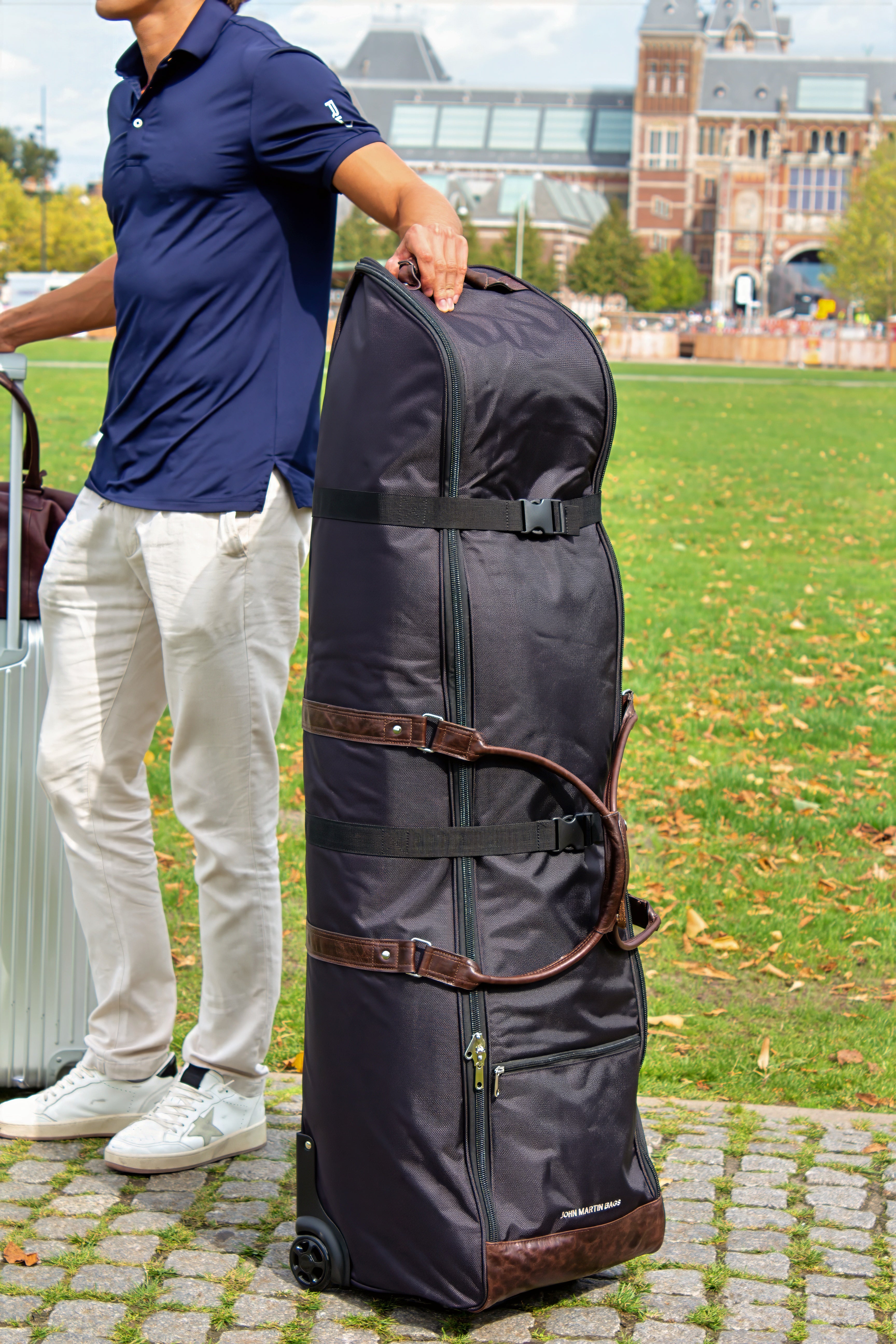 Man standing with the John Martin Golf Travel Bag in Amsterdam.