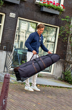 Man holding the John Martin Golf Travel Bag in Amsterdam.